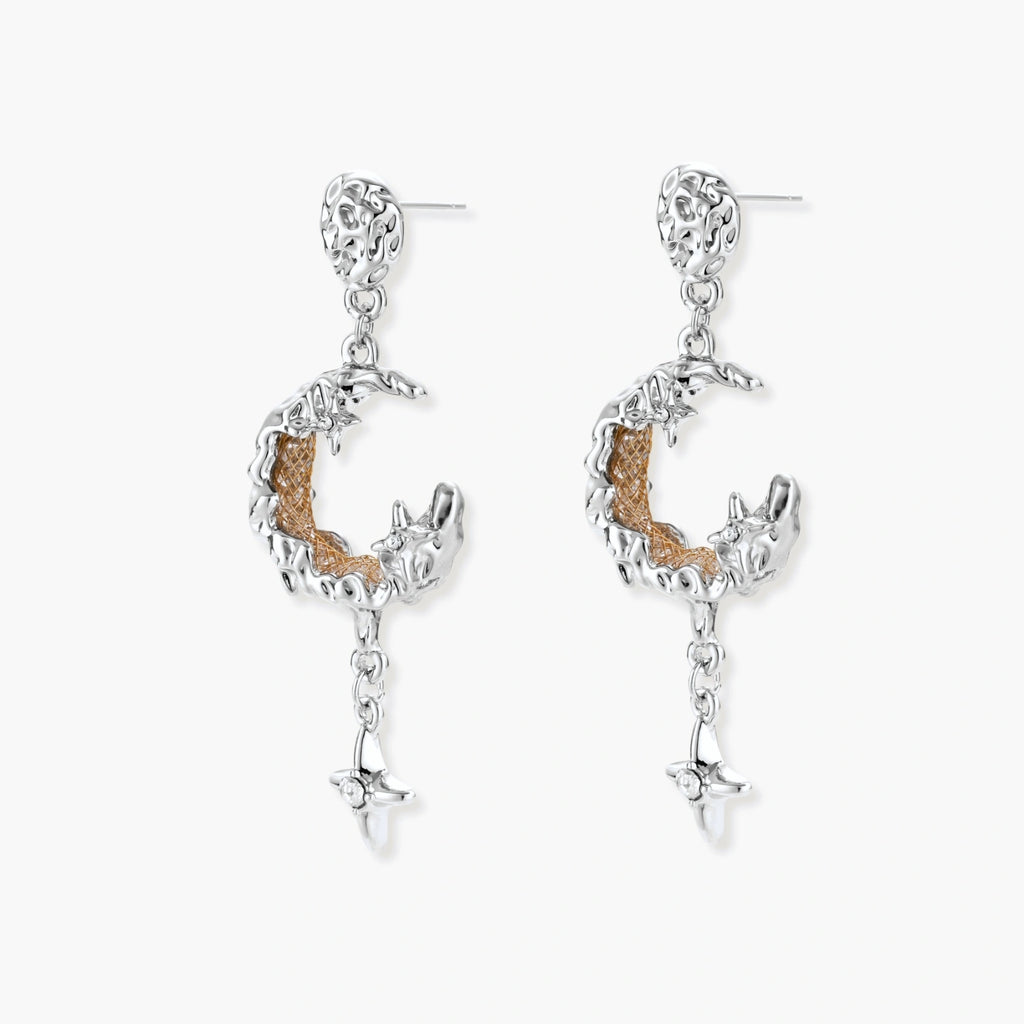 Detailed eco-brass dangle earrings featuring crescent moons with gold rope details and dangling star charms on white background.
