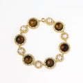 Gold-plated link bracelet with alternating brown tiger's eye stones and white freshwater pearls in ornate bezels.